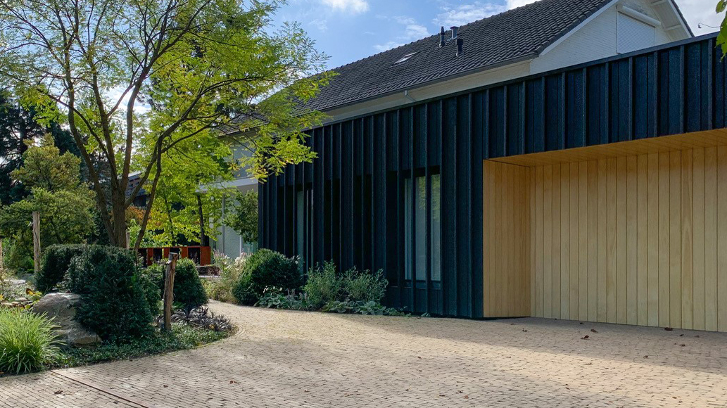 Charred Accoya cladding and uncoated Accoya garage door - Accoya